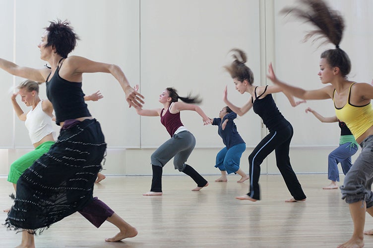 Students dance in a studio during a class.