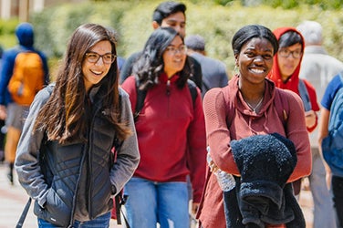 Smiling students make their way across campus.