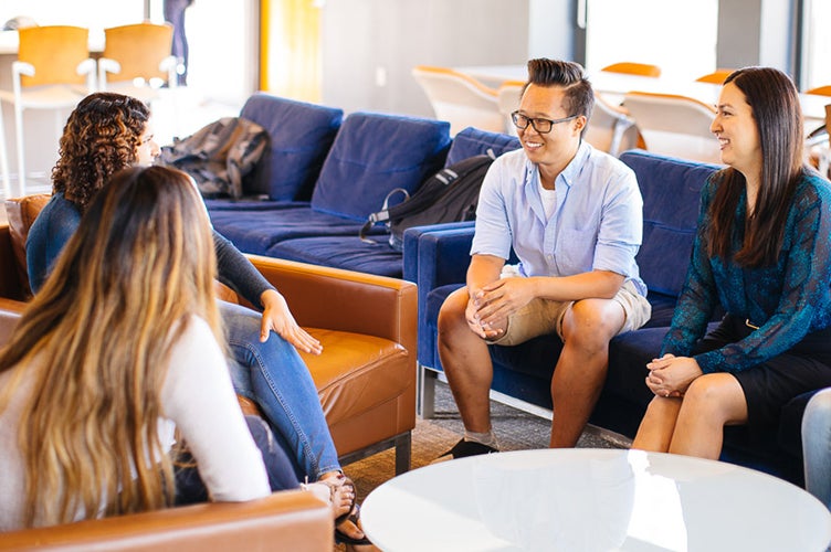 Students talk in a lounge.
