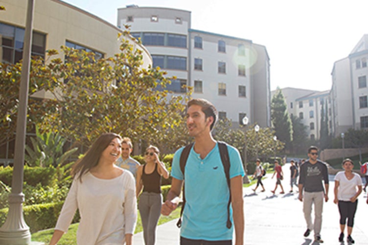Students walk across campus near the Hill.