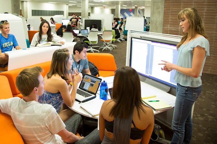 An instructor talks to a group of students in Charles E. Young Research Library.
