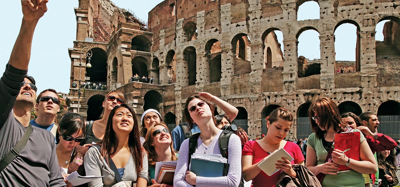 A group of students marvels at a historical site in Greece.