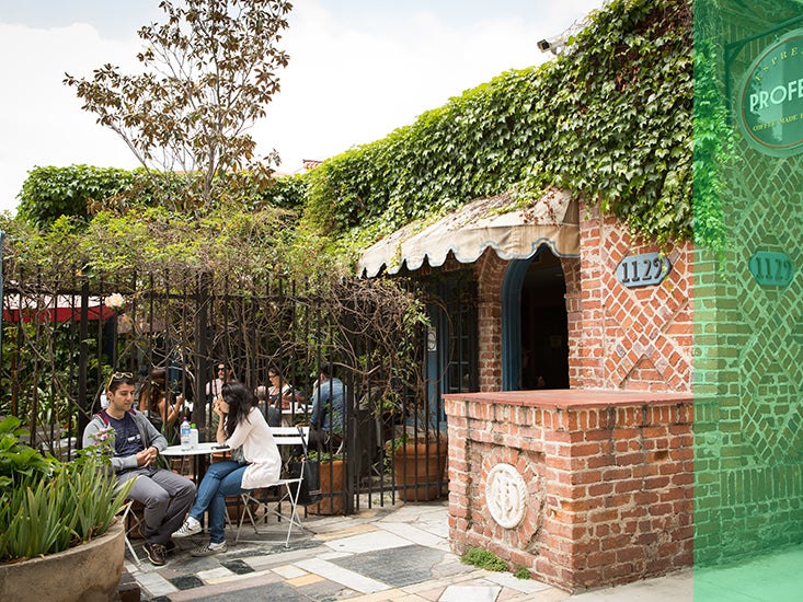 Students talk and relax over on the charming patio of a coffee shop in Westwood.
