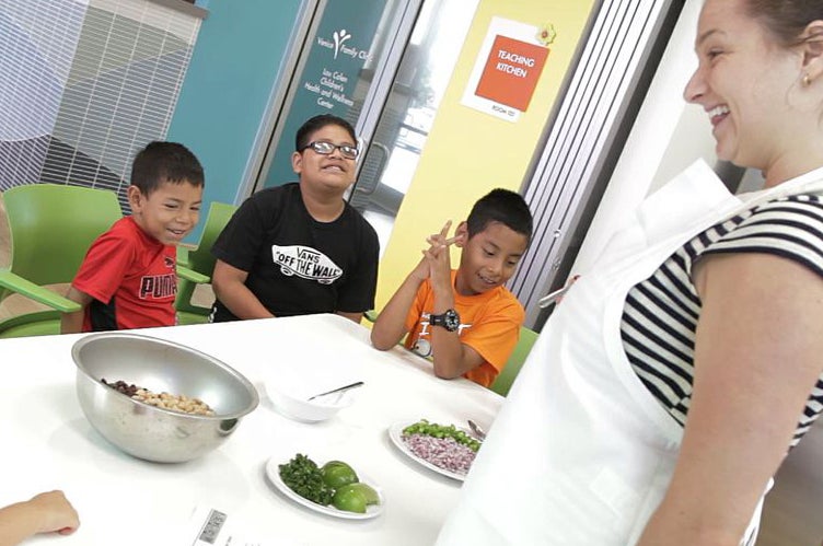 A student teaches kids about healthy eating.