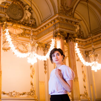 Sarah Brandenburg poses in a historic ballroom inside the Musée d’Orsay.