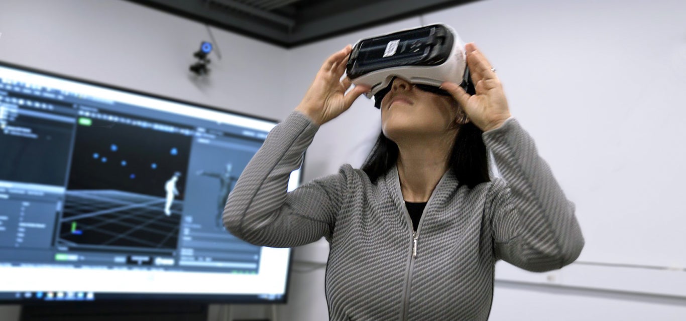 UCLA neuroscientist Nanthai Suthana models virtual reality glasses used in her research.