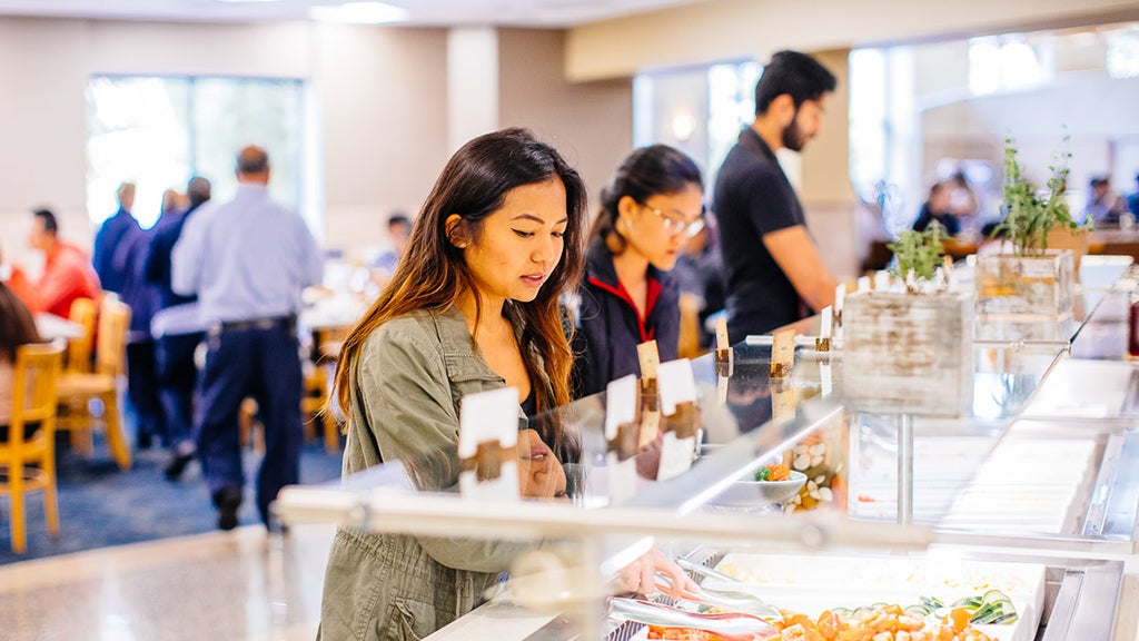 Students take food at a self-serve bar at Bruin Plate.