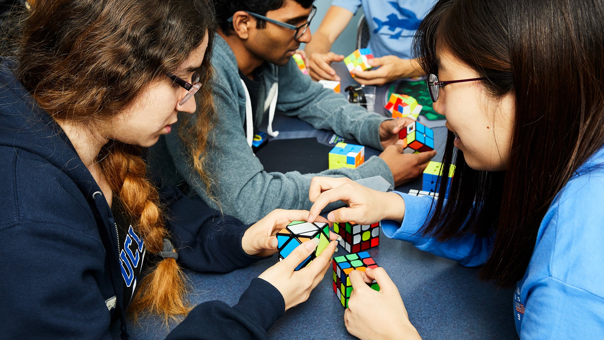 Cubing Club at UCLA members pose together with their Rubik’s Cubes.