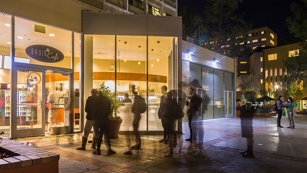 Students get food and drinks at Bruin Cafe at night.