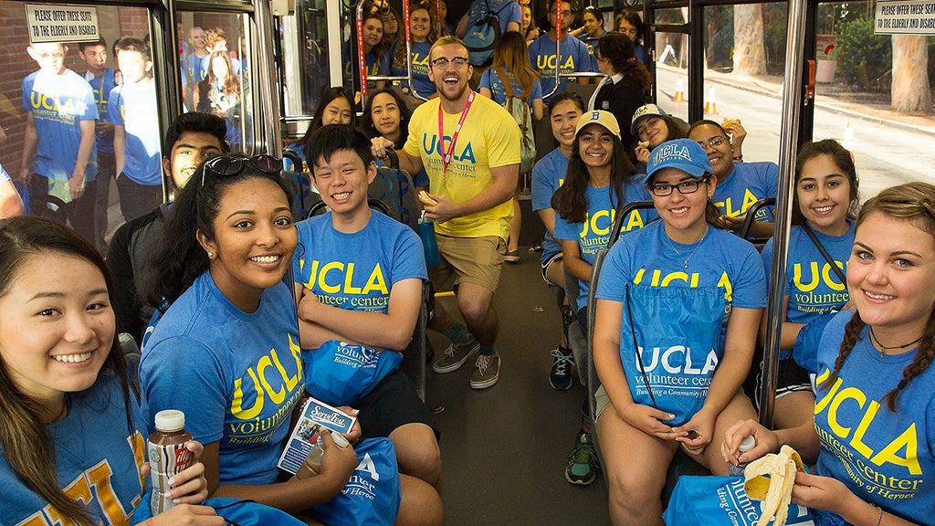 Volunteer Day participants ride a bus together en route to a charitable event.